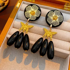 Vintage gold butterfly and black floral bead drop earrings in a luxury wooden gift box