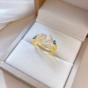 Gold open ring with pavé zircon star, moon and evil eye motifs in a premium gift box
