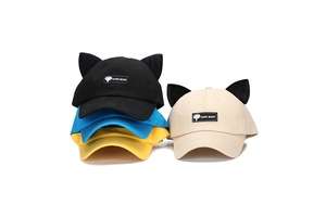Detail of creative baseball caps with cat ears and handmade labels in multiple colors