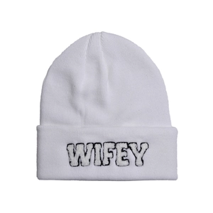Detail of WIFEY embroidery on white cuffed knit beanie with premium ribbed texture