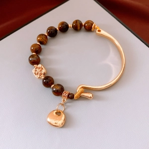Detail of 18K gold-plated clasp and tiger eye beads on the vintage round bracelet
