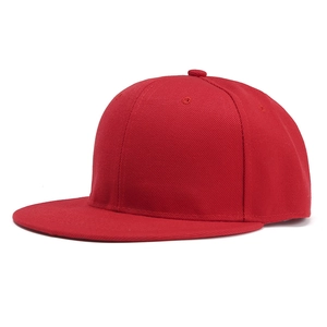 Macro detail of red snapback hat with twill fabric texture and flat brim design