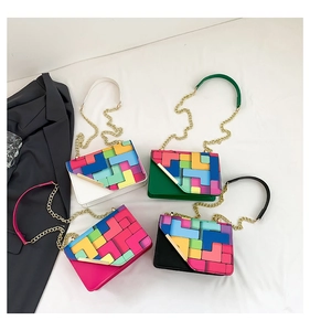 Detail view of four colorful crossbody square bags with rainbow geometric pattern and chain