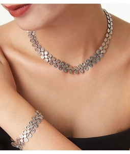 On-model view of silver sunflower necklace and bracelet set in polished titanium steel