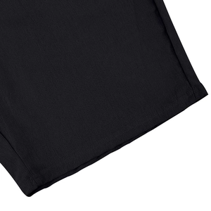 Detail of black linen beach shorts showing high-quality plain weave and neat double stitching