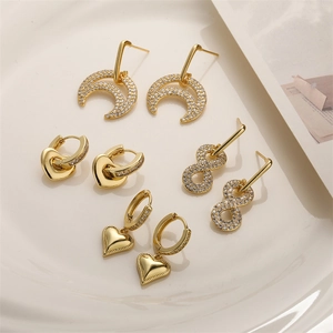 Set of four gold-plated earrings with moon, heart, and infinity symbol designs
