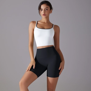 Detail of high-waist slimming black cycling shorts and white camisole sports set