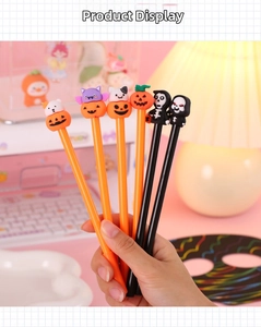 Detail shot of Halloween cartoon gel pens featuring pumpkin and ghost decorative toppers
