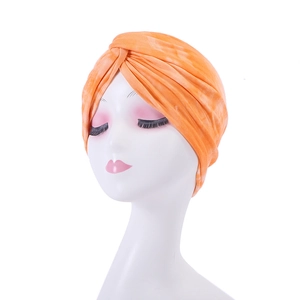 Detailed view of orange tie-dye texture on a soft breathable beanie turban hat