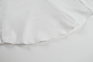Détail de couture machine et tissu sergé blanc sur l'ourlet de la robe moulante
