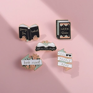 Five creative book-themed enamel pins in various colors for students and avid readers