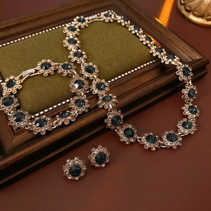 Vintage floral jewelry set with blue gemstones and diamonds including necklace and bracelet