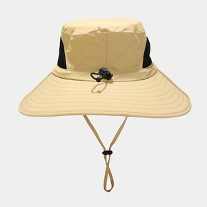 Detail view of beige outdoor sun hat showing breathable black mesh and wide brim stitching