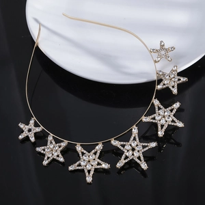 Sparkling gold bridal headband with zircon five-pointed stars on reflective surface
