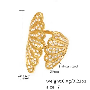 Macro detail of gold stainless steel wing ring with zircon inlay and size measurements