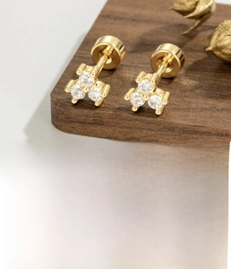 Macro shot of 18K gold triangular zircon cartilage earring with screw back and dimensions