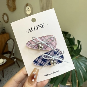Pink and blue plaid bow hair clips with acrylic hearts and silver metallic details