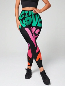 Close-up of high-waisted yoga leggings with colorful graffiti print and seamless texture