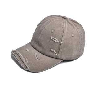 Close-up of distressed brim details on a vintage washed canvas baseball cap