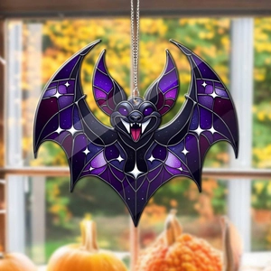 Detailed view of a purple acrylic bat hanging ornament against an autumn window background