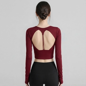Slim fit burgundy long sleeve yoga top featuring heart-shaped back cutout and strappy detail