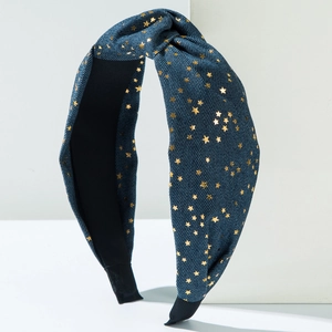 Detail of blue denim headband featuring gold star prints and a classic top knot design