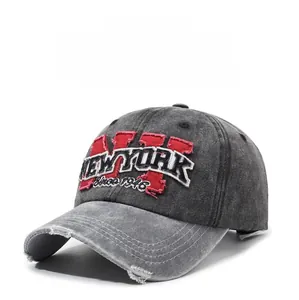 Detail of vintage washed gray denim baseball cap with New York embroidery and distressed brim