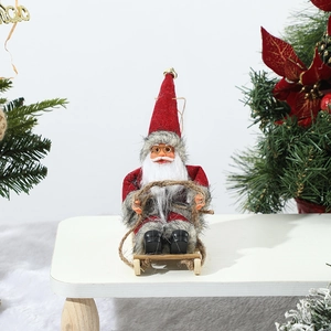Detail of Christmas Santa doll with red hat and gray fur on a mini wooden sleigh base