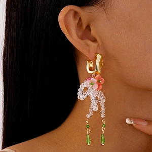 Floral resin earrings with crystal bow tassels and gold C-hoop in a sweet vacation style