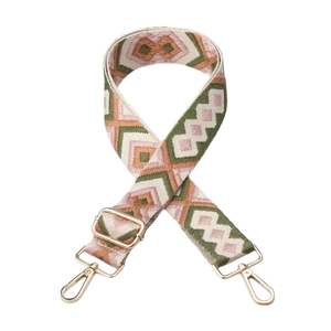 Close-up of pink and green geometric embroidery on adjustable fabric bag strap