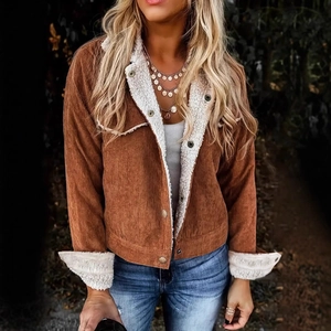 Detail of caramel corduroy jacket with white fleece lining and metal button closure