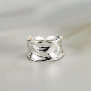 Close-up of a silver irregular wrinkled texture ring with an adjustable open design