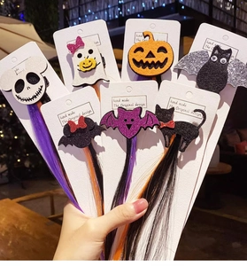 Detail of Halloween hair clips with colorful synthetic hair and festive felt characters
