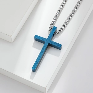 Macro shot showing the matte blue frosted texture of the titanium steel cross pendant