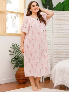 Detail of pink plus size nightgown with lace neckline, flamingo and polka dot pattern