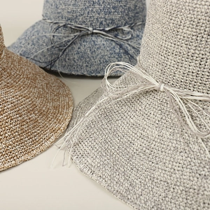Handmade crochet straw hats for women in blue, brown, and grey with decorative ribbon ties