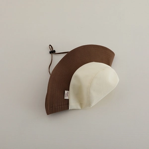 Detailed view of color-block kids sun hat with adjustable windproof cord and cotton texture