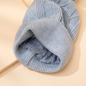 Detail view of the thick gray knit beanie showing textured weave and soft fleece lining