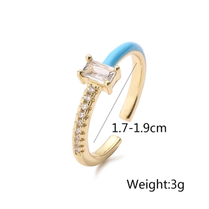 Detail of 18K gold plated ring featuring blue enamel accents and rectangular zircon stone