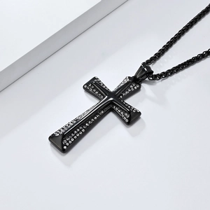 Detail of a black hip-hop cross pendant with inlaid rhinestones and matching chain link