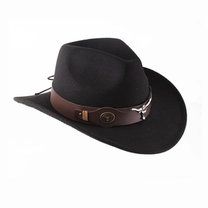 Close-up of black felt cowboy hat with brown leather band and metal bull head ornament