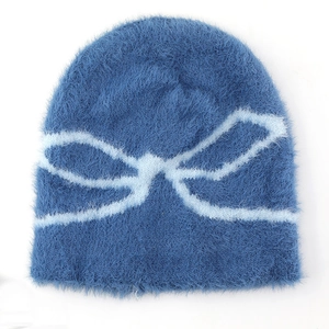 Detail showing plush navy knit beanie texture with light blue butterfly bow pattern