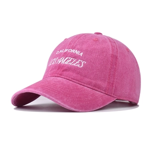 Close-up of California and Los Angeles white embroidery on washed pink cotton cap