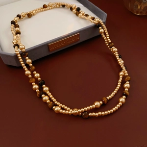 Detail of vintage double-layer necklace with faux tiger eye stones and golden pearls