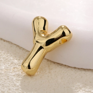 Macro view of gold plated bubble letter Y pendant with mirror polish for DIY jewelry