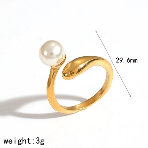 Detail view of a gold snake-shaped ring with a white pearl and size specifications