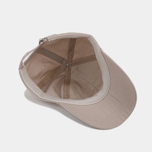 Inside view of khaki cotton baseball cap showing sweatband and internal stitching