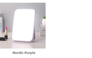 Detail of Nordic purple folding makeup mirror with adjustable stand on a neat vanity desk