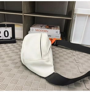 White minimalist waterproof chest bag with black nylon strap and bright orange zipper detail