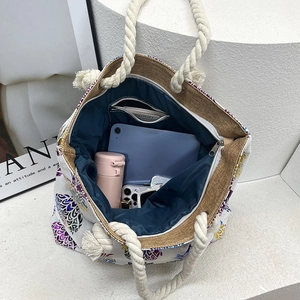 Linen canvas tote bag with thick rope handles and spacious blue interior shown from top view
